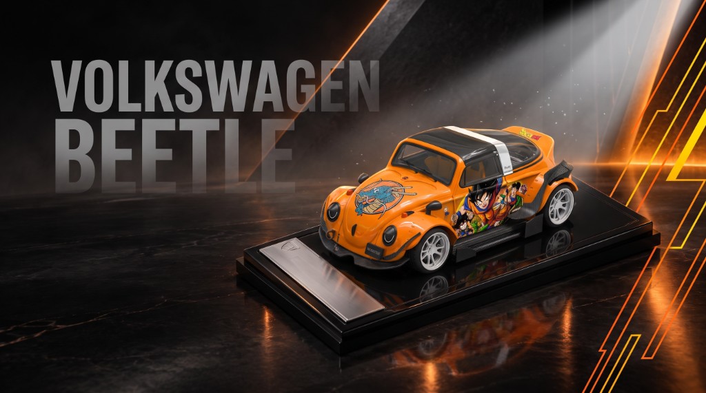 Orange Volkswagen Beetle on a black plinth under a warm spotlight
