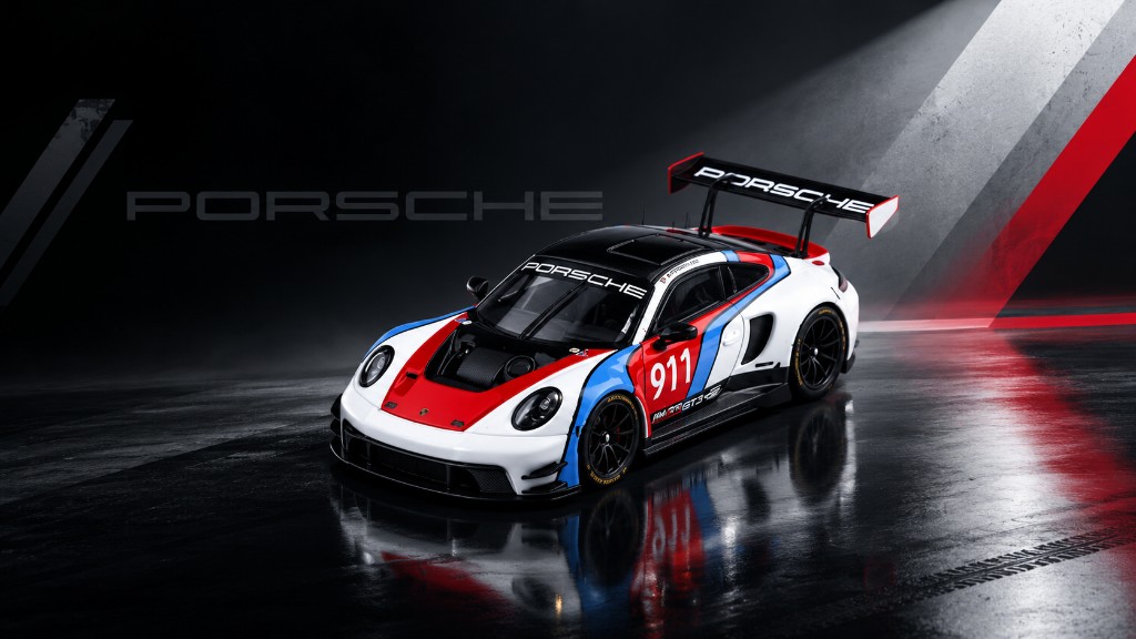 Porsche 911 GT3 R in white, red, and blue on a wet floor